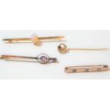 An opal bar brooch, stamped '15CT', length 6.4cm; an amethyst bar brooch, stamped '9CT', length 4.