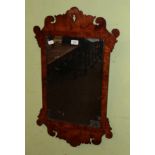 A 19th century walnut and elm fret work mirror