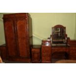 A Victorian four-piece burr walnut bedroom suite comprising a double door wardrobe fitted with