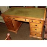 A Gillows satin birch double pedestal desk inset with green leather top, 129cm diameter