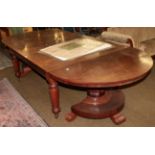 An impressive Victorian mahogany extending dining table, raised on faceted tapering legs, the twin