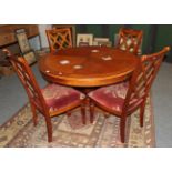 A reproduction cherrywood circular dining table, the quarter-veneered and crossbanded top on a