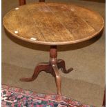 A George III provincial oak circular tilt top tripod table