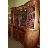 A George III breakfront bookcase, the moulded and dentil cornice above two glazed doors flanked by