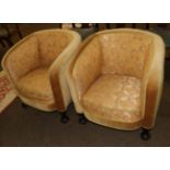 A pair of yellow upholstered tub chairs