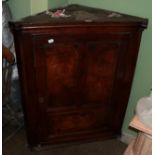 An elm hanging corner cupboard circa 18th century