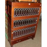 A mahogany three-tier stacking bookcase with leaded glass doors