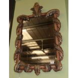 A carved giltwood mirror, the rectangular plate within an acanthus carved frame with decorative