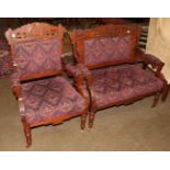 A late 19th century American walnut open armchair and a two-seater settee, of Arts and Crafts
