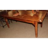 An oak plank top farmhouse table, cleated ends, square tapered legs