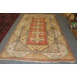 Melas Carpet, the terracotta field with five floral medallions enclosed by double borders, 302cm by