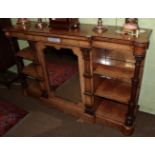 A Victorian figured walnut breakfront credenza, mirrored central door flanked by shelves, with inset