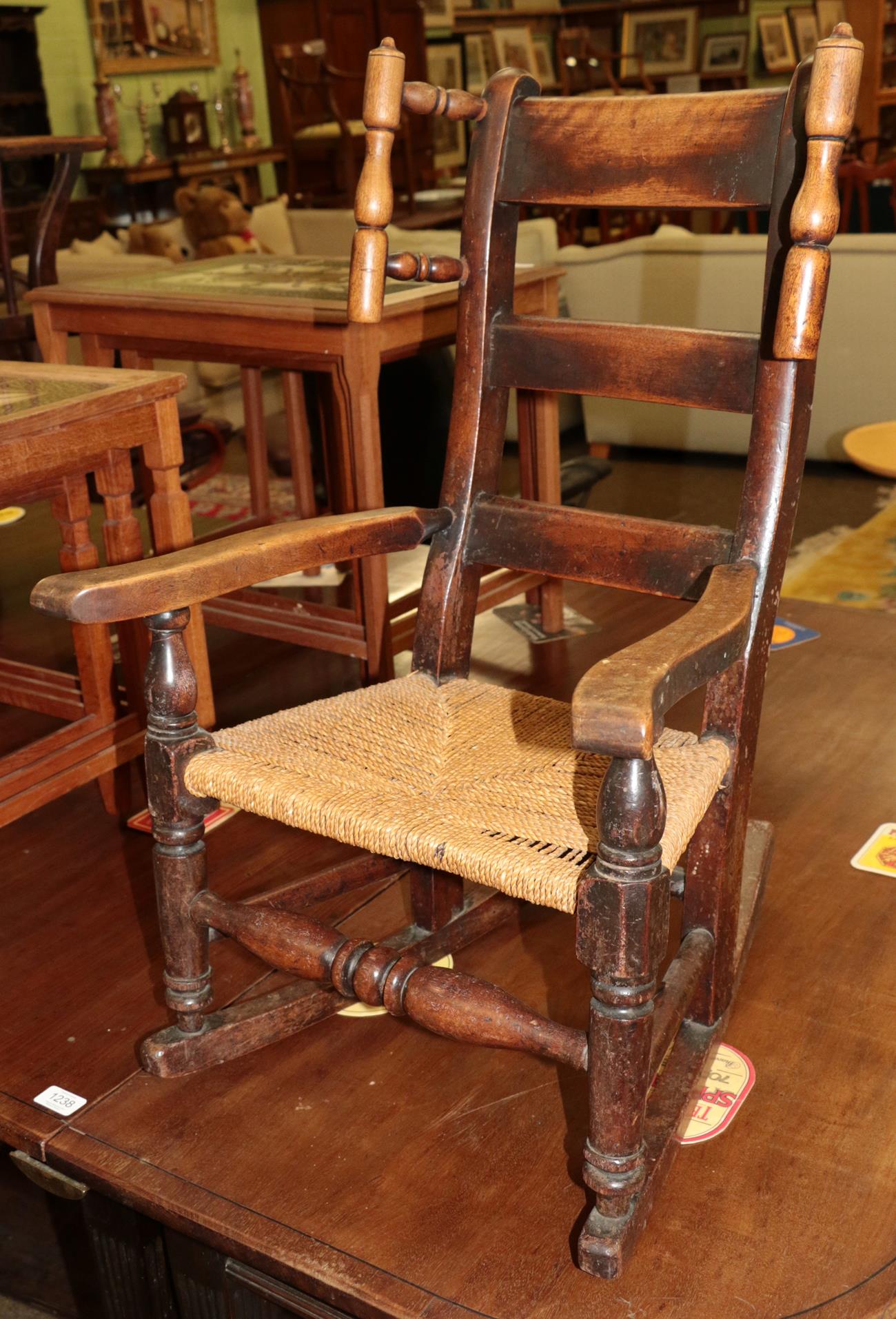 A mid 19th century elm child's chair with rush seat