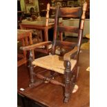 A mid 19th century elm child's chair with rush seat