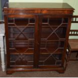 A reproduction mahogany bookcase, with glazed astragal doors, on bracket feet