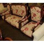 A late 19th century walnut framed three piece suite recovered in floral fabric