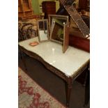 A late 19th century gilt decorated dressing table fitted three frieze drawers, on fluted legs, 137cm