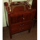 A George III mahogany tray top commode, with cupboard doors above a two-as-one drawer enclosing a