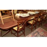 A reproduction mahogany and crossbanded triple pillar dining table, 365cm (extended) by 107cm by