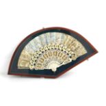 A Mid-19th Century Ivory Fan, the carved and well-shaped monture gilded in two shades of gold. The