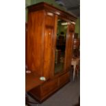 A Victorian mirror fronted panelled wardrobe fitted with two base drawers; and a 19th century