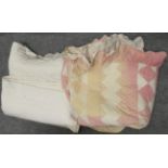 Late 19th century cream reversible quilt with pleated frill to the edge, another pink and white