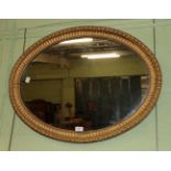A gilt wood oval mirror