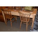 A Victorian pine kitchen table, fitted two drawers, 150cm long; together with two pine kitchen