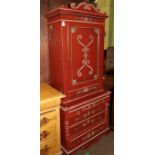 A late 19th century Danish red painted cabinet on chest, with scrollwork adorned pediment and single