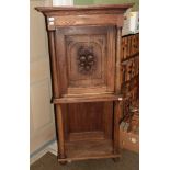A 19th century Danish oak cabinet on stand, integral cornice, single door with carved fruit panel,