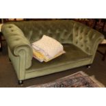 A late Victorian two-seater Chesterfield, upholstered in green buttoned velvet, 152cm wide