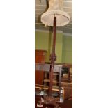 An early 20th century carved mahogany standard lamp and shade
