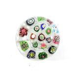 A Clichy Spaced Millefiori Paperweight, circa 1850, set with various coloured canes on a gauze