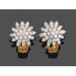 A Pair of Diamond Cluster Earrings, the cluster of round brilliant cut diamonds in white claws,