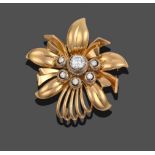 A Diamond Brooch, the stylised flower with round brilliant cut diamonds set centrally, total