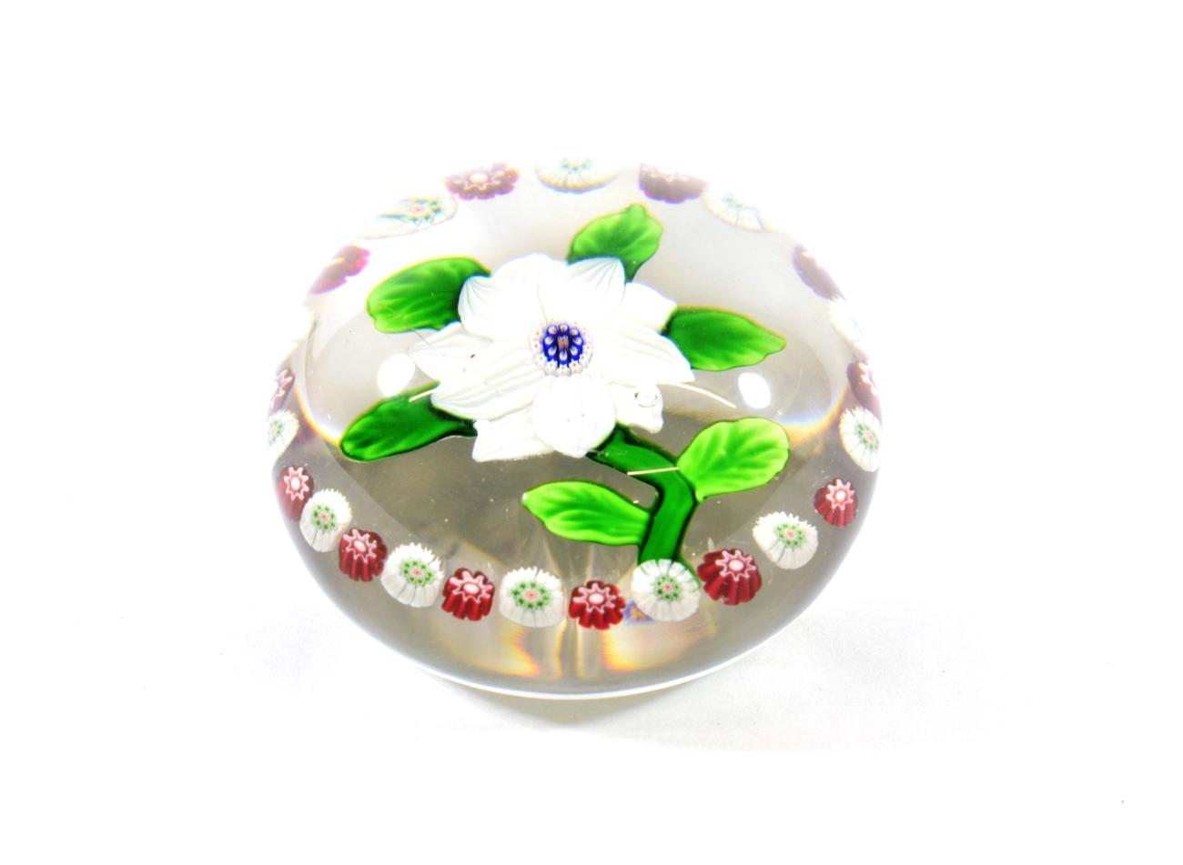 A Baccarat Garlanded Double Clematis Paperweight, circa 1850, with two rows of striped white leaf