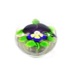 A Baccarat Pansy Paperweight, circa 1850, with two purple petals and three yellow petals outlined in