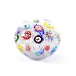 A Baccarat Spaced Millefiori Paperweight, dated 1848, set with various silhouette and other canes on