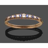 A Sapphire and Diamond Bangle, circa 1880, six graduated oval cut sapphires alternate with seven old