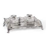 A George V Silver Inkstand, by William Hutton and Sons, Sheffield, 1912, oblong and on four scroll