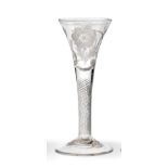 A Jacobite Wine Glass, circa 1750, the drawn trumpet bowl engraved with a rose and two buds on a