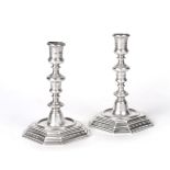 A Pair of Queen Anne Silver Candlesticks, by William Denny, London, 1702, each on stepped square