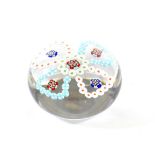 A Baccarat Patterned Millefiori Paperweight, circa 1850, with central canes within four pale blue,