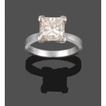 A Platinum Diamond Solitaire Ring, the princess cut diamond in a four claw setting to knife edge