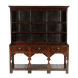 An 18th Century Joined Oak Open Dresser and Rack, with two fixed shelves, the base of three frieze
