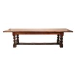 A Substantial Stained Pine Rectangular Refectory Dining Table, the four plank top with cleated