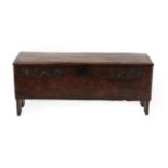 An Oak Chest, dated and initialled 1701 EAT, of six plank construction, the hinged lid above an iron