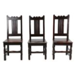 A Set of Three English Joined Oak Back Stools, circa 1700, each seat rail stamped EI, with wavy