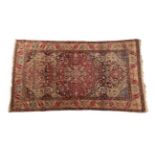 Isfahan Rug Central Iran, circa 1925 The abrashed walnut brown field centred by a cusped raspberry