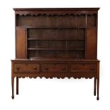 A Mid 18th Century Oak and Mahogany Crossbanded Dresser and Rack, the moulded cornice above a wavy